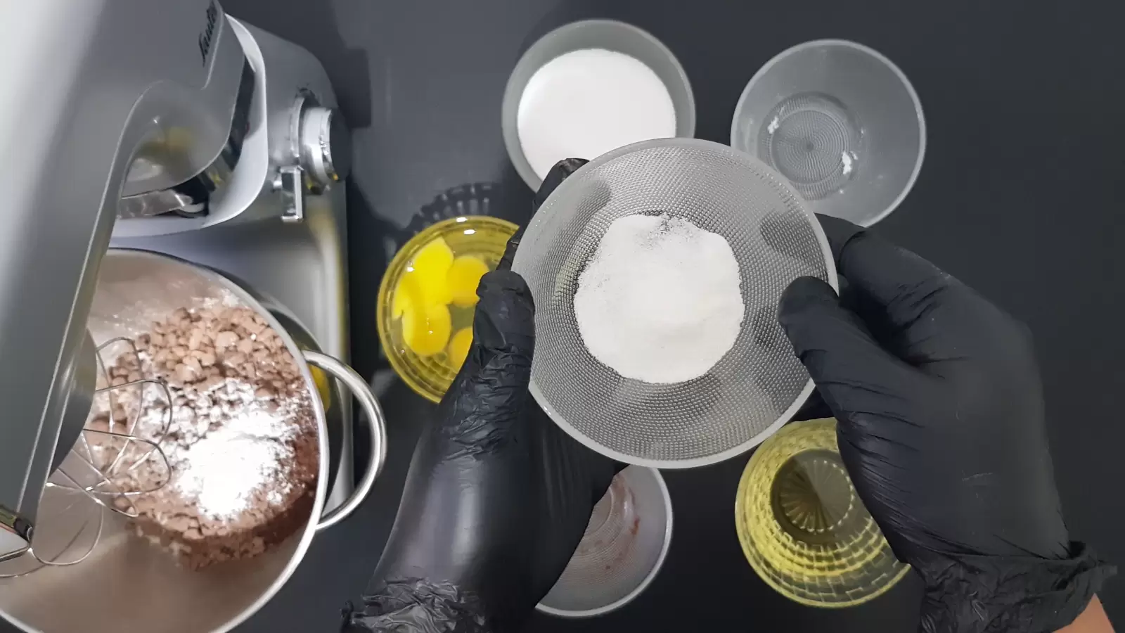 Bowl with vanilla sugar, empty bowl, bowl with oil, bowl with sugar, bowl with eggs, mixer with bowl