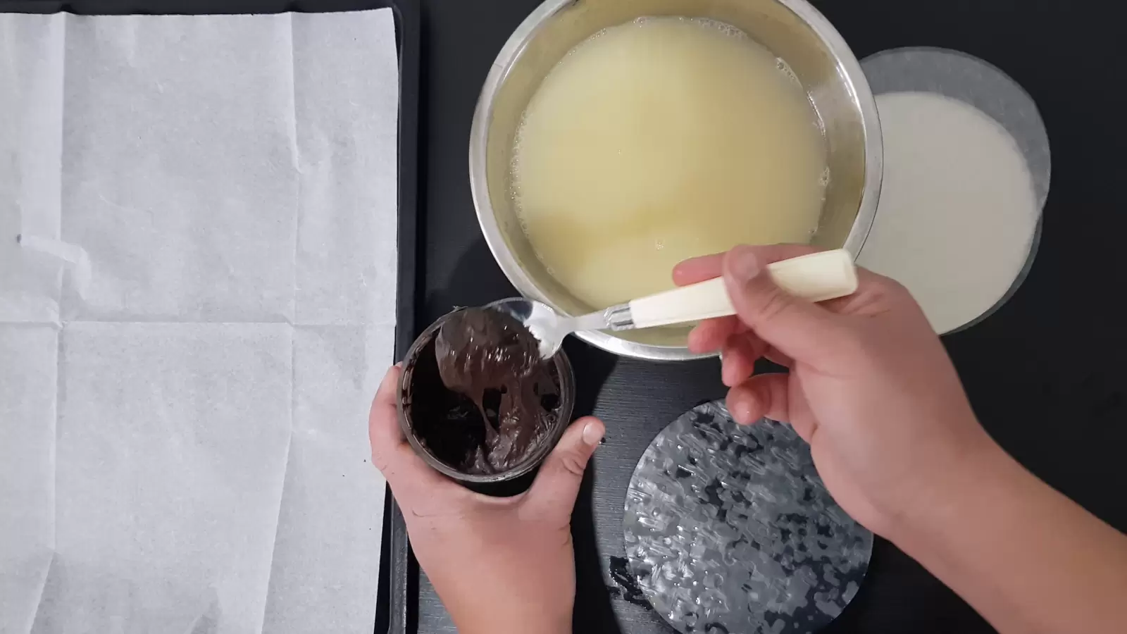 Rice paper, a bowl with water and egg, a jar with chocolate spread and a spoon, rice paper on the table, a baking sheet with baking paper