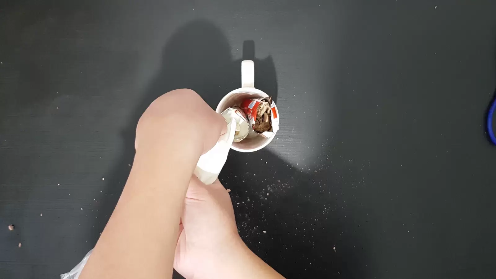 Kinder Bueno packages in a cup, whipped cream poured inside