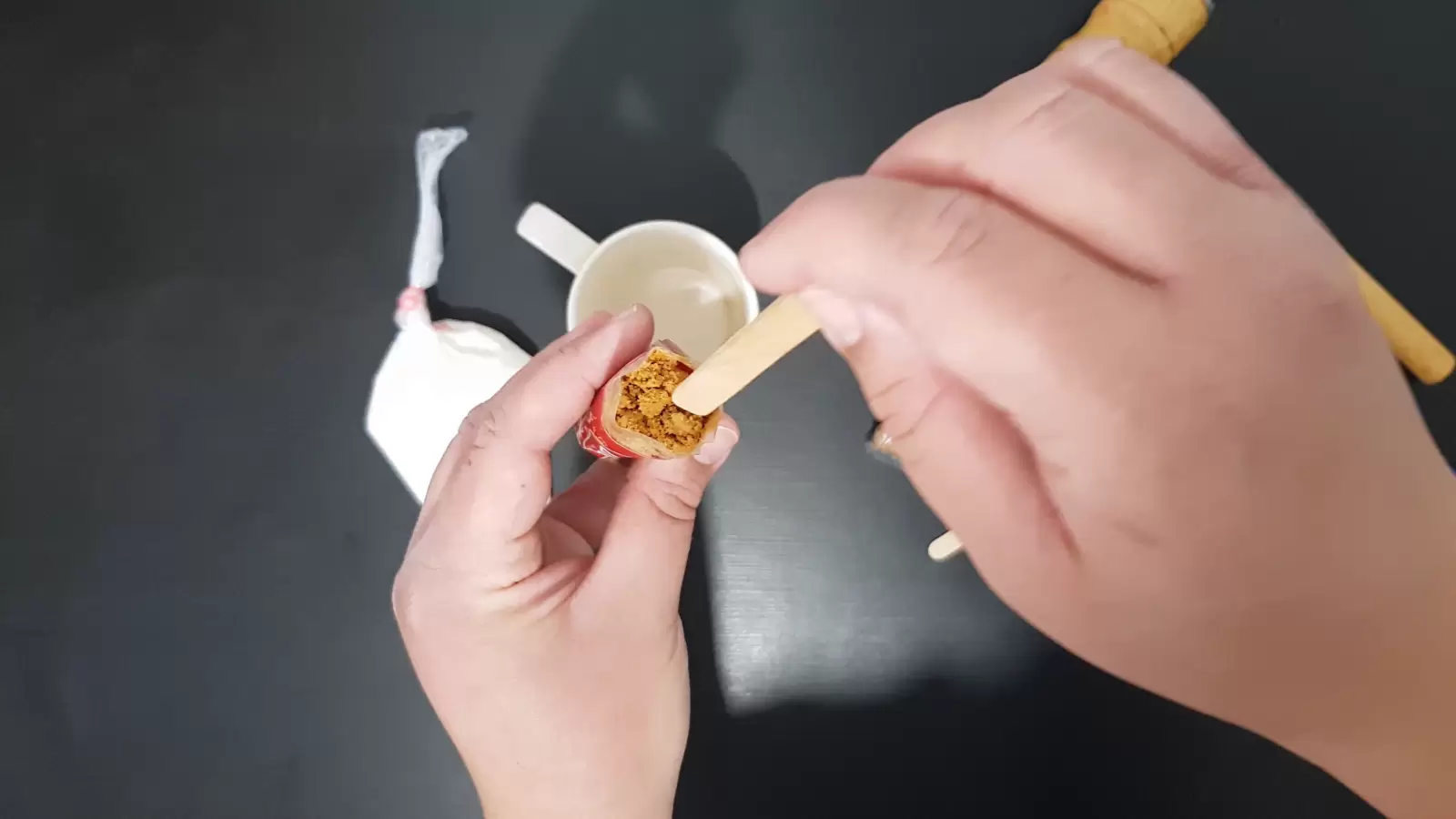 Cup, whipped cream, stick inside a lotus biscuit