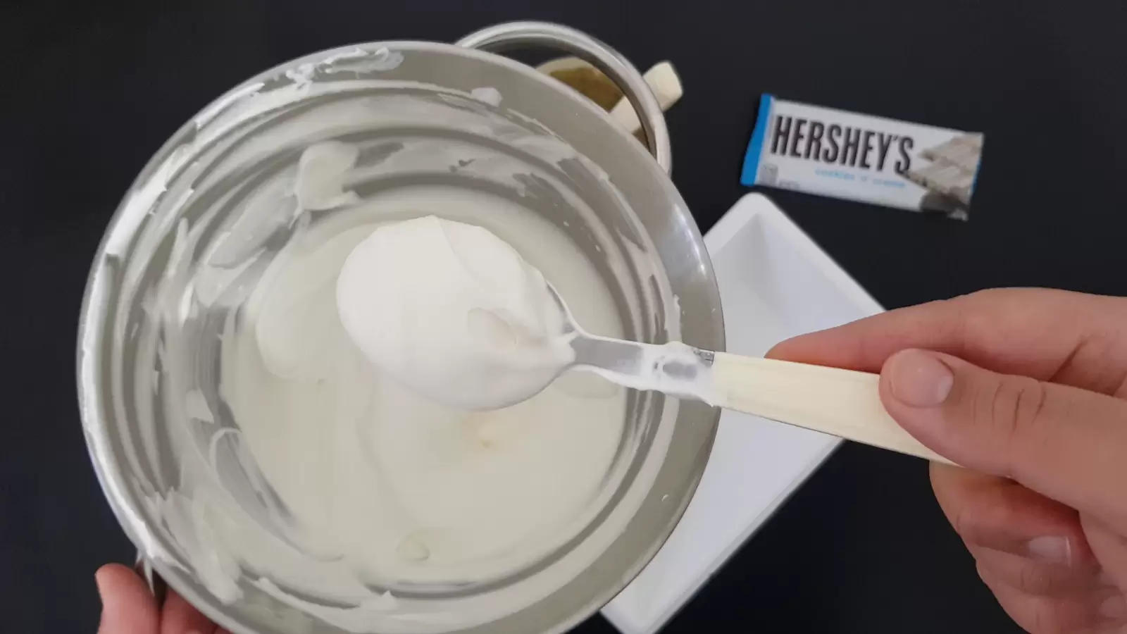 a bowl with whipping cream, a package of Hershey\\'s chocolates, an ice cream box