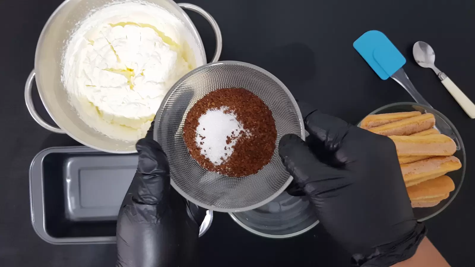 Bowl with coffee and sugar, bowl with ladyfingers, mixer bowl with cream, pan, spoon