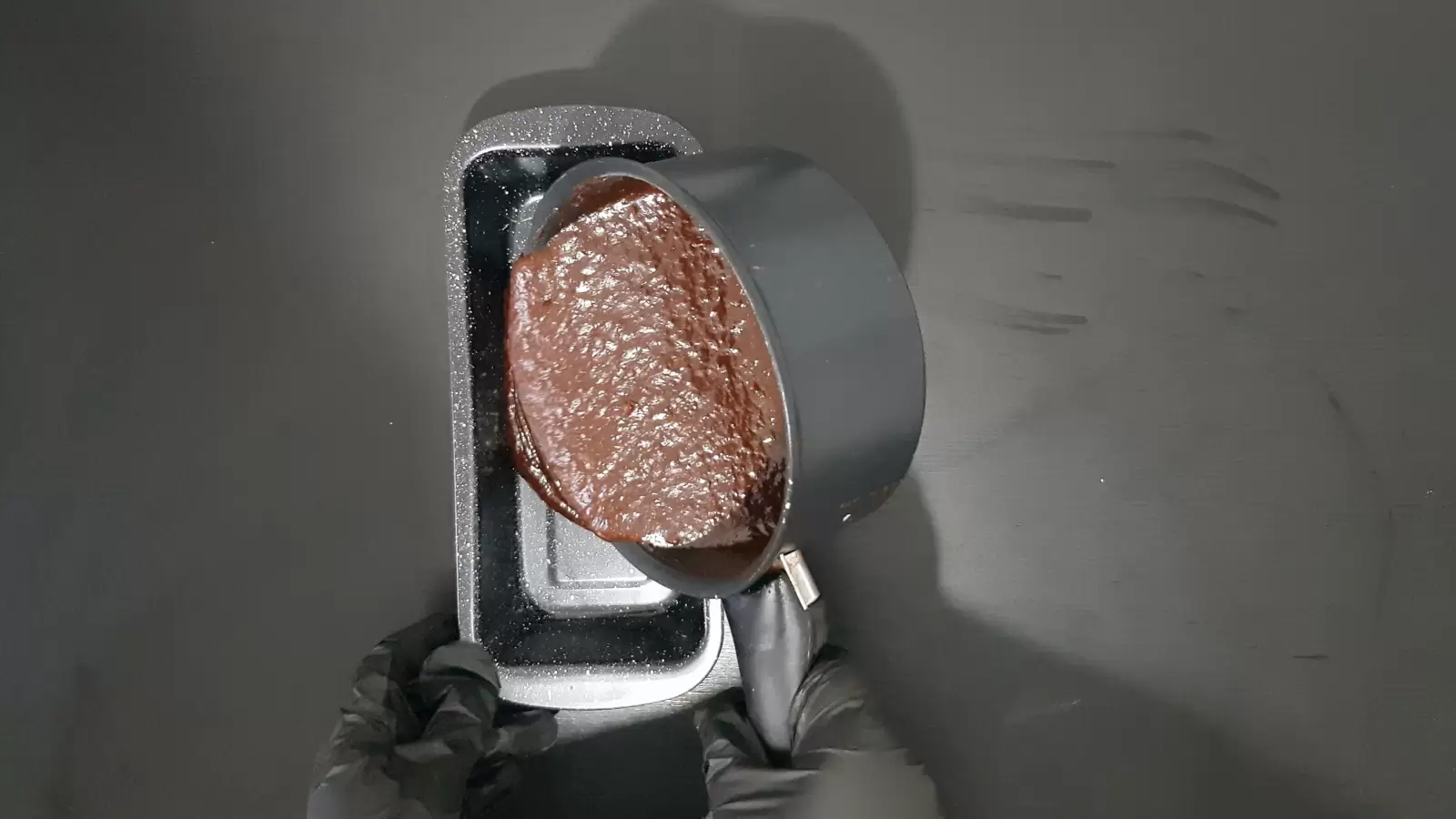 Pot with chocolate batter poured into pan