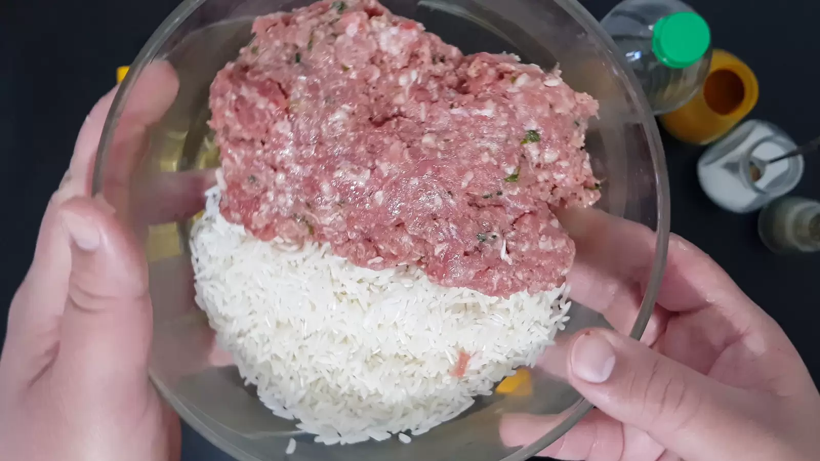 Bowl with minced meat and rice, jar of turmeric, jar of salt, bottle of oil