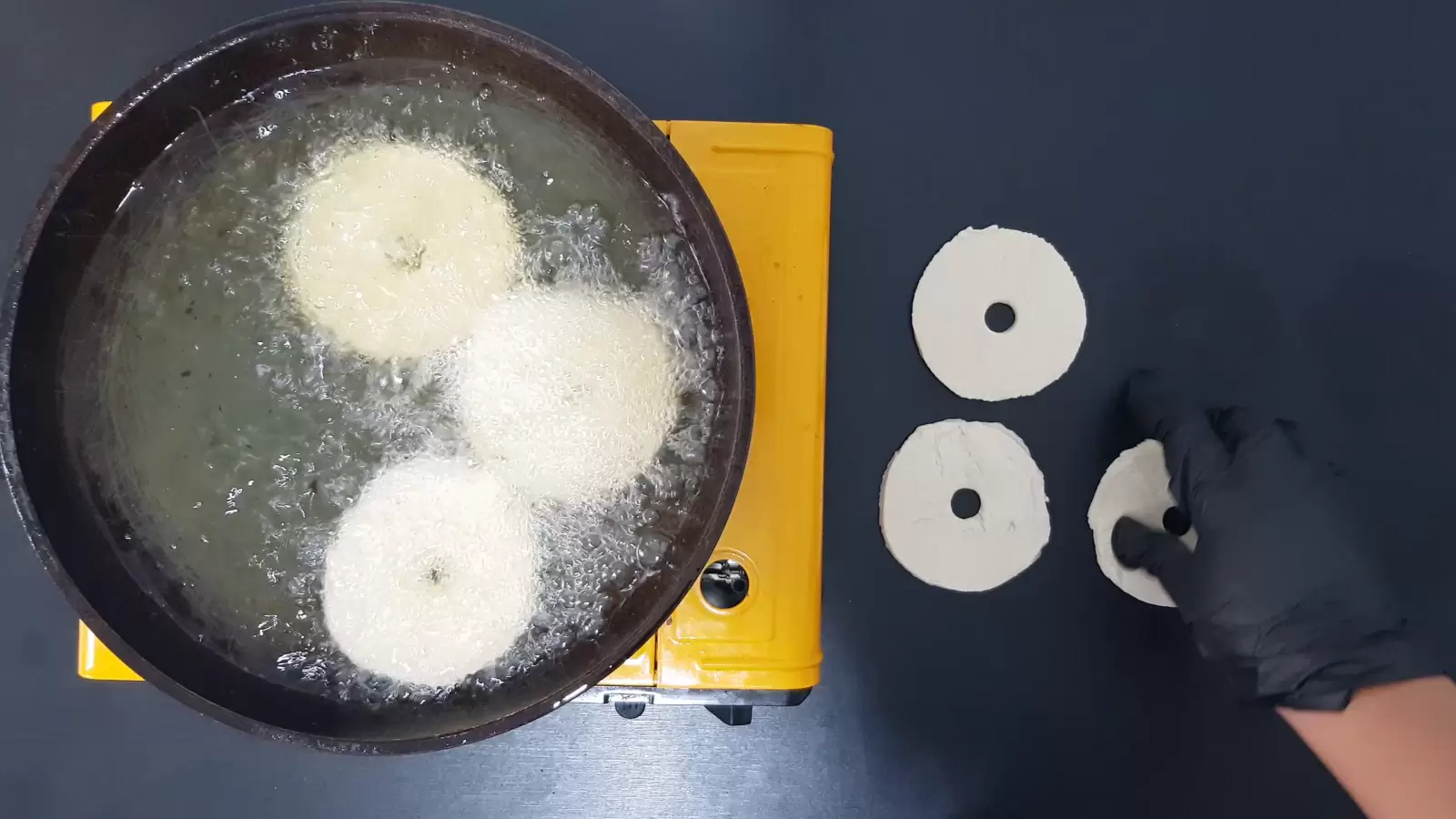 Pan with oil, puff pastry donuts