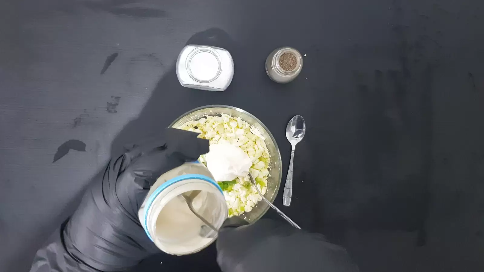 Pepper jar, salt jar, bowl with eggs and mayonnaise, spoon, mayonnaise jar