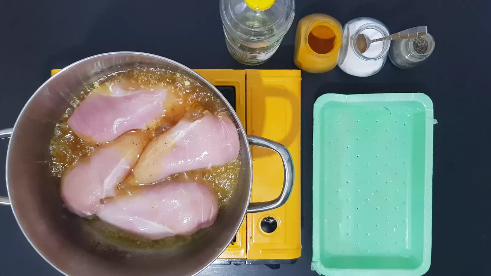 Spices, chicken breast in a pot