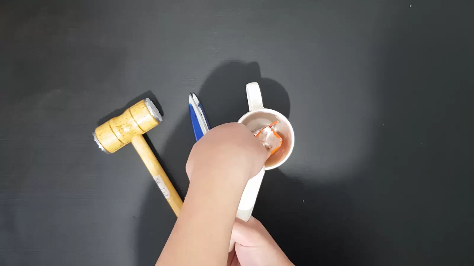 Sweet cream pouring into a mug, kitchen hammer
