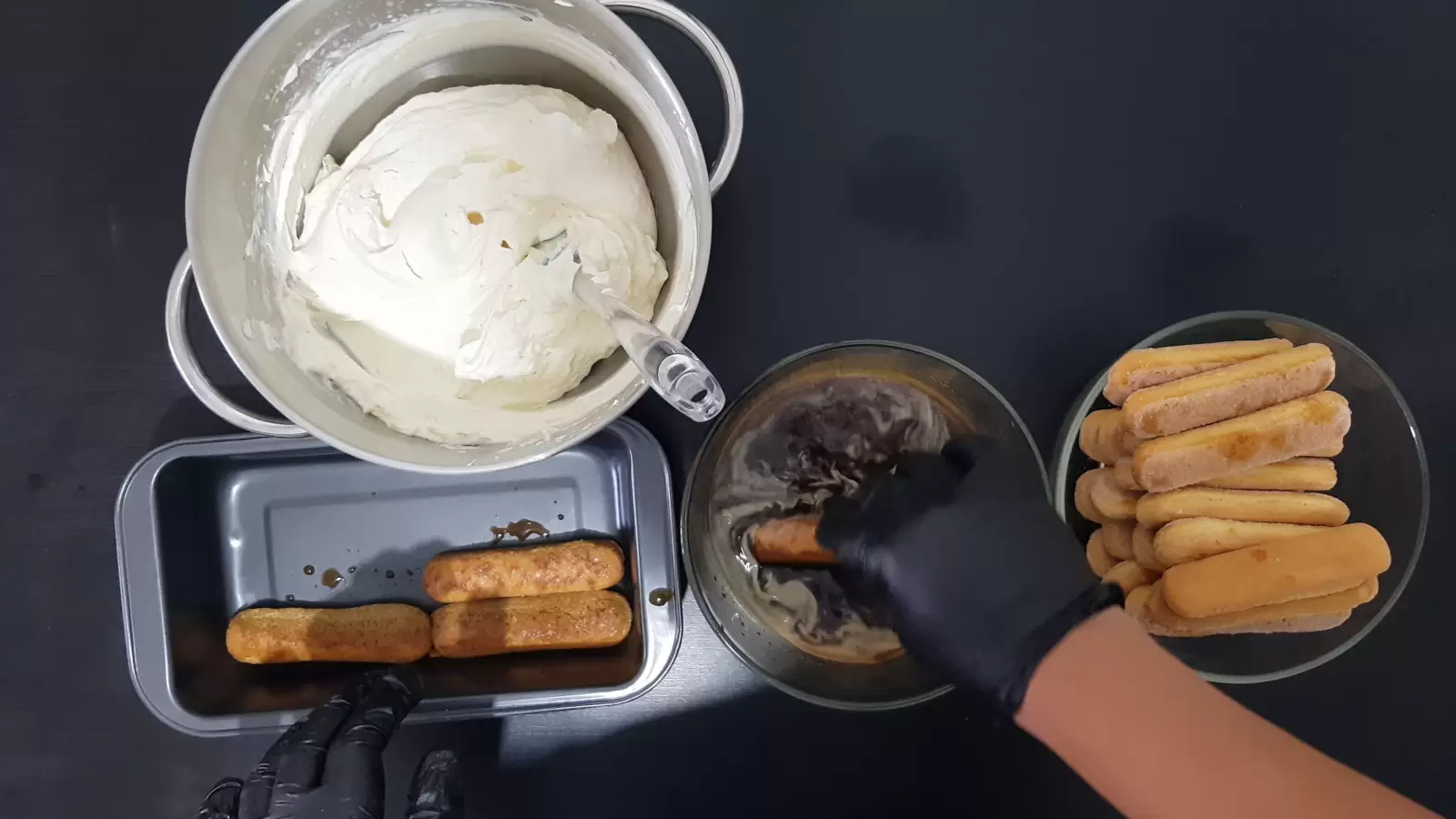 Bowl with coffee spoon and sugar, bowl with ladyfingers, mixer bowl with cream, pan