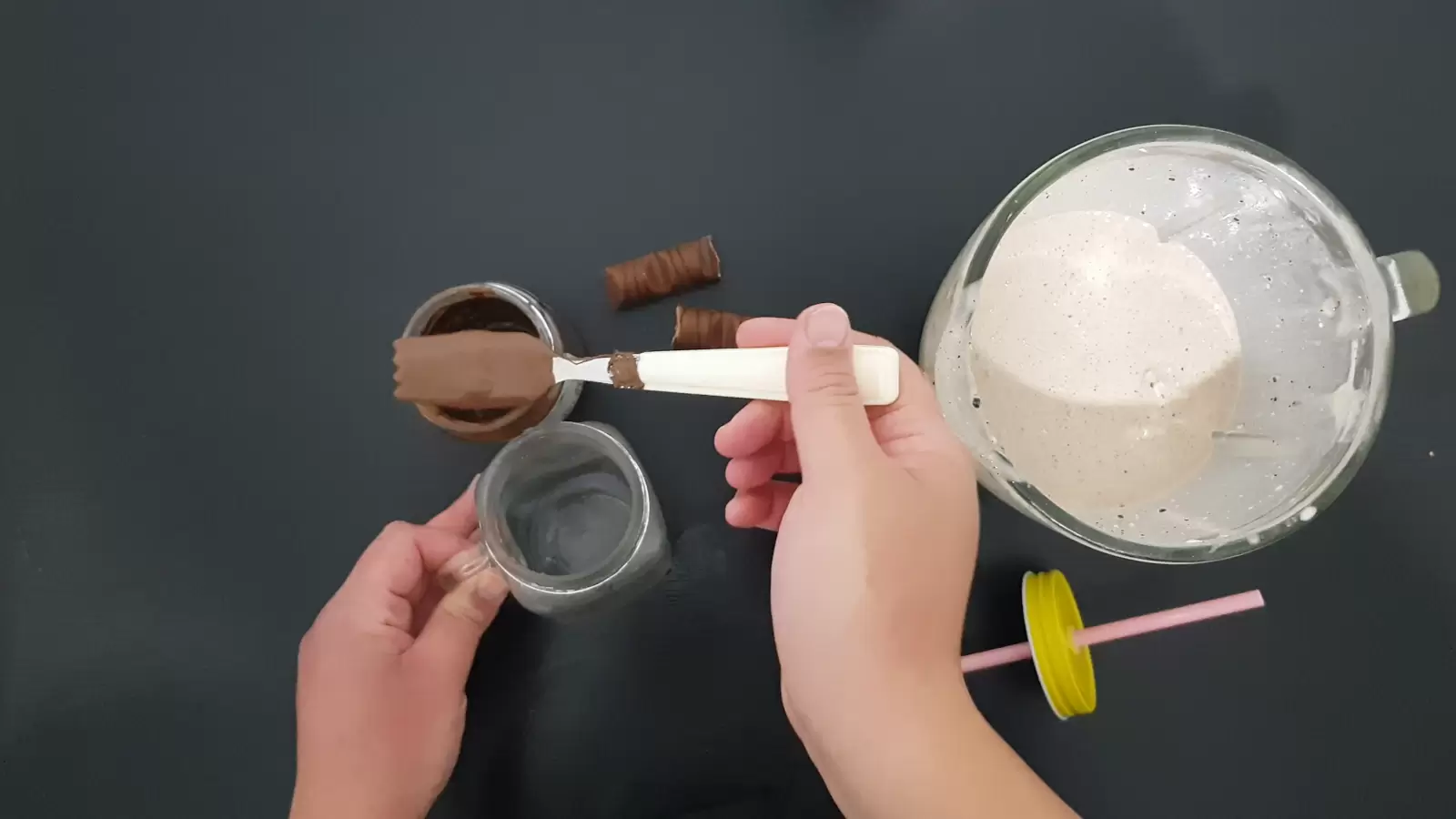 Blender with milkshake, fork with chocolate, cup