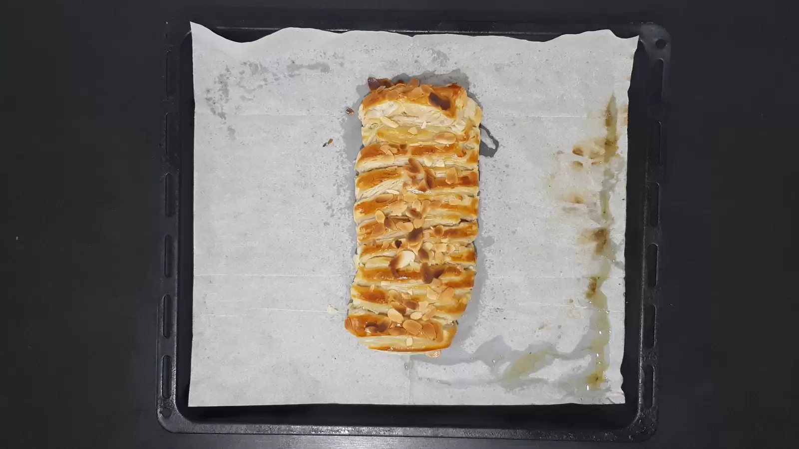 Puff pastry with Milka chocolate on a baking sheet with baking paper