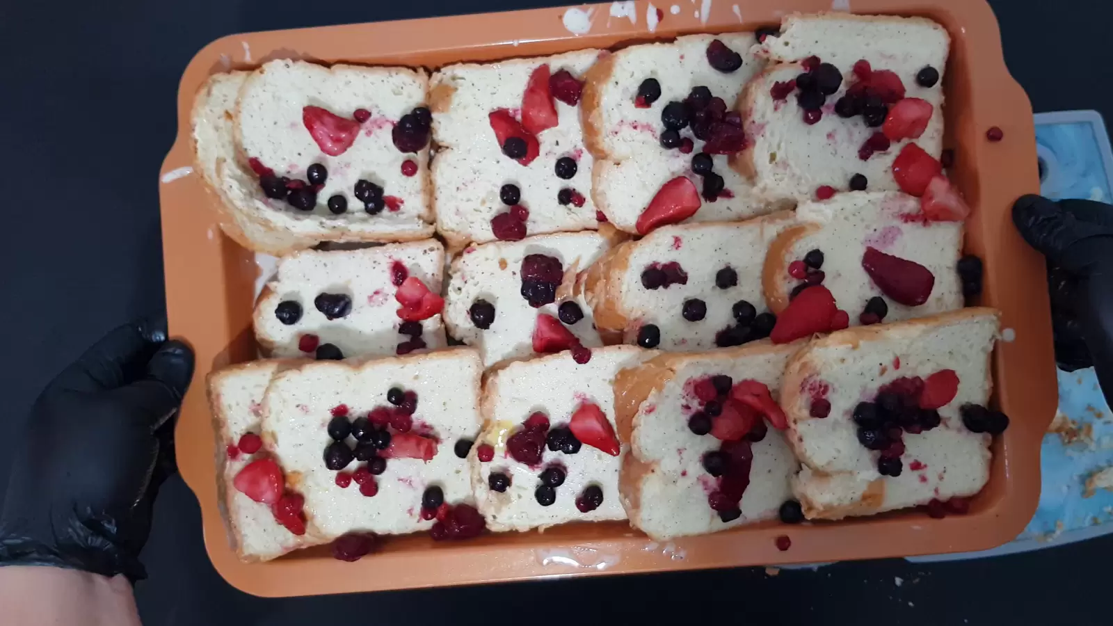 Baking pan with Berry Bread Pudding and berries on top