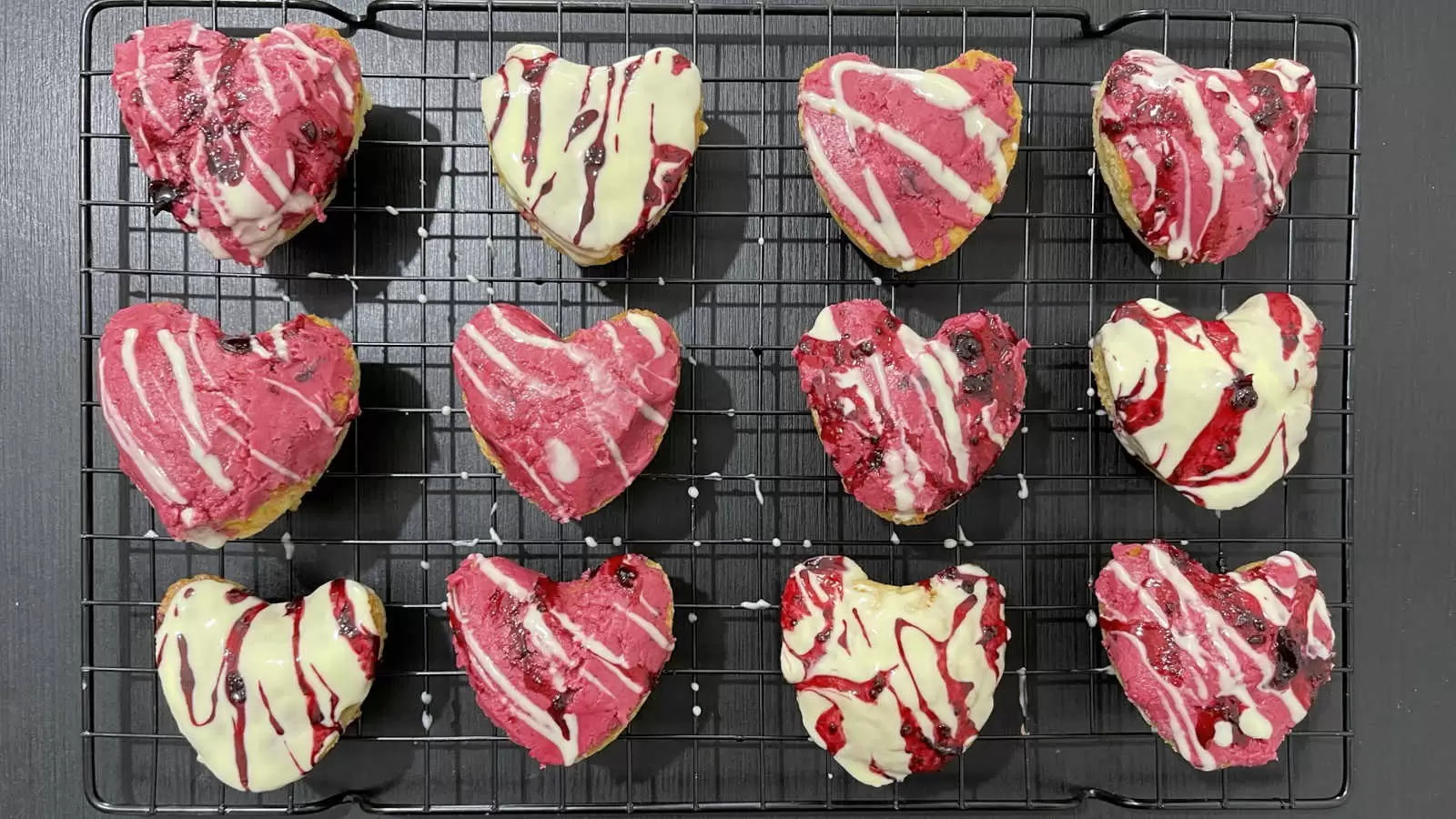 Vanilla and berry cupcakes dish on a cooling rack