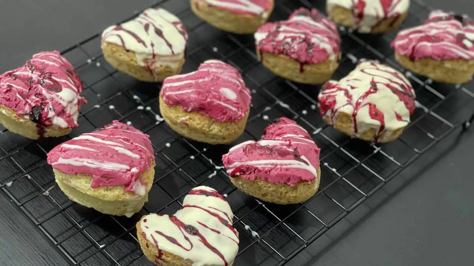 Vanilla and berry cupcakes recipe on a cooling rack