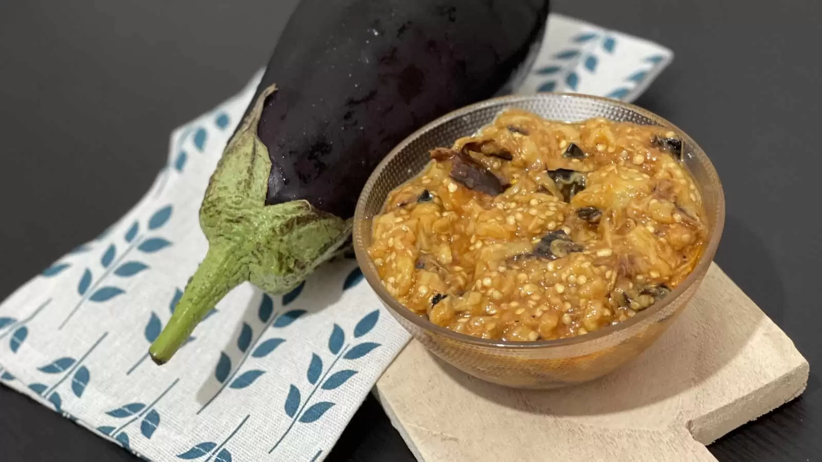 Eggplant on a napkin Vegetarian eggplant salad in a bowl on a wooden tray