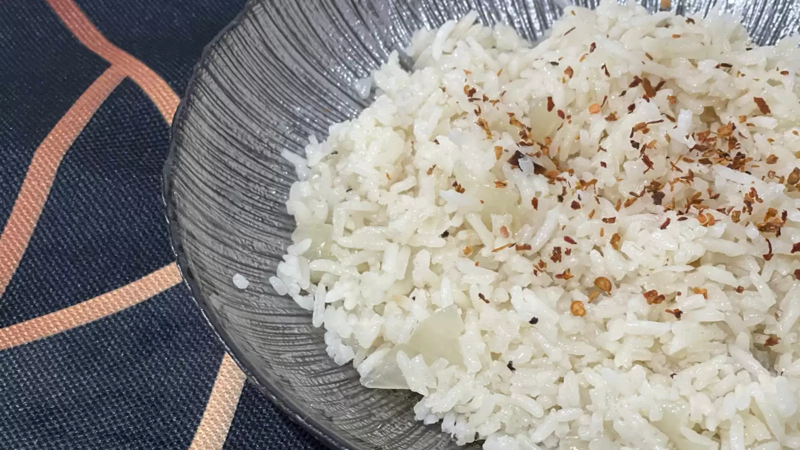 Vegetarian rice on a plate with a spoon under a napkin