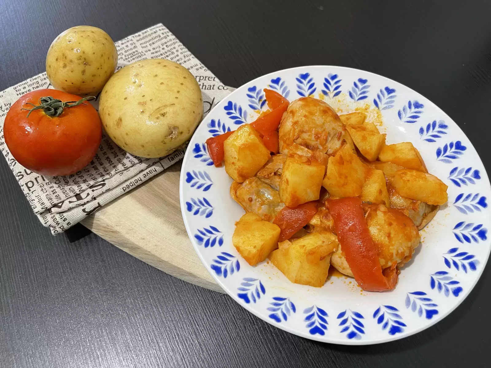 Tasty chicken and potatoes in tomato sauce